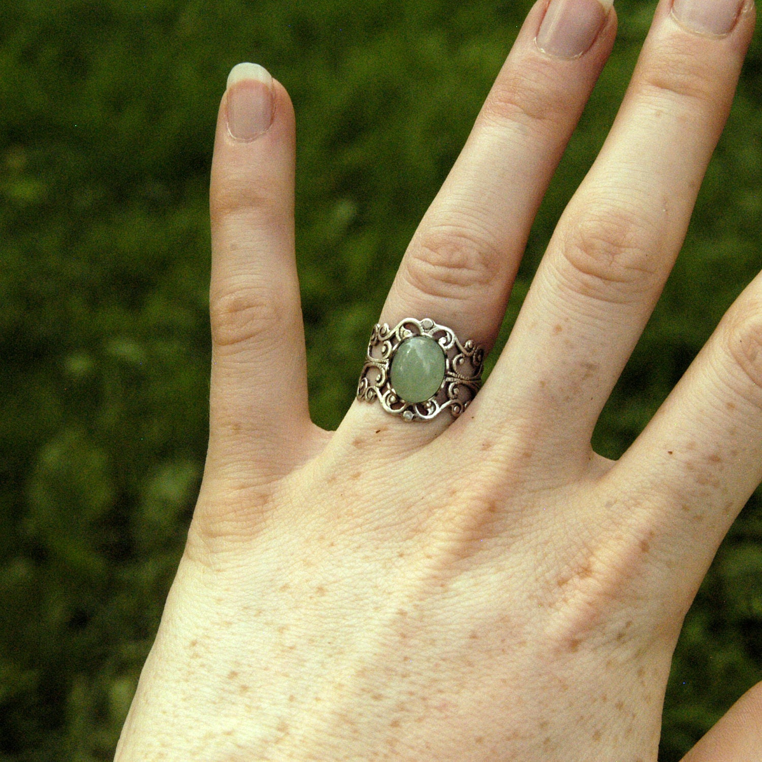 Antiqued silver modern vintage inspired adjustable filigree cocktail ring with a green aventurine semi-precious stone in the danish pastel style.
