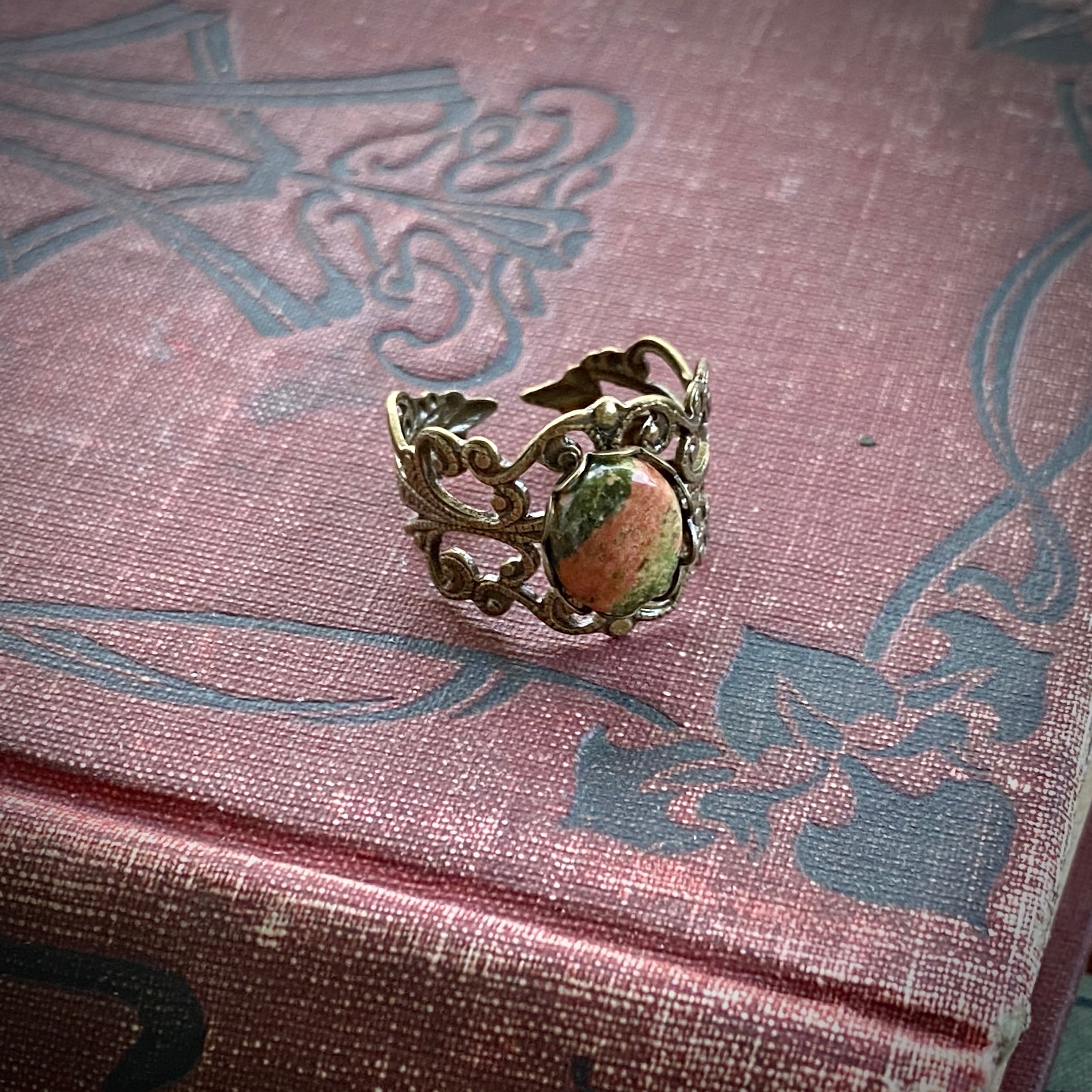 Antiqued brass modern vintage inspired adjustable filigree cocktail ring with orange and green unakite semi-precious stone oval mineral in a skater aesthetic