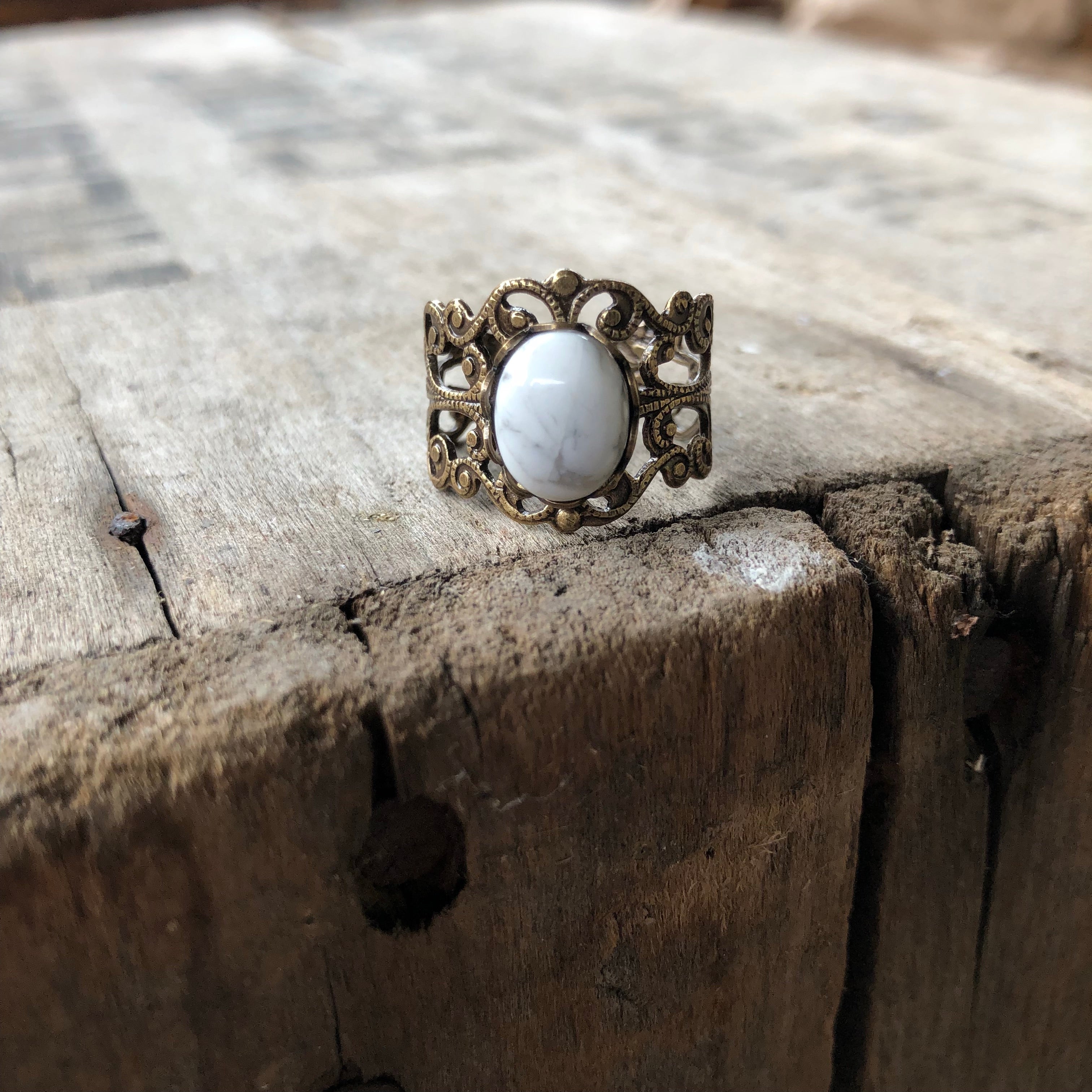 rich bronze colored antiqued brass modern vintage inspired adjustable filigree ring with a white marble howlite semi-precious mineral oval stone in the winter academia esthetic