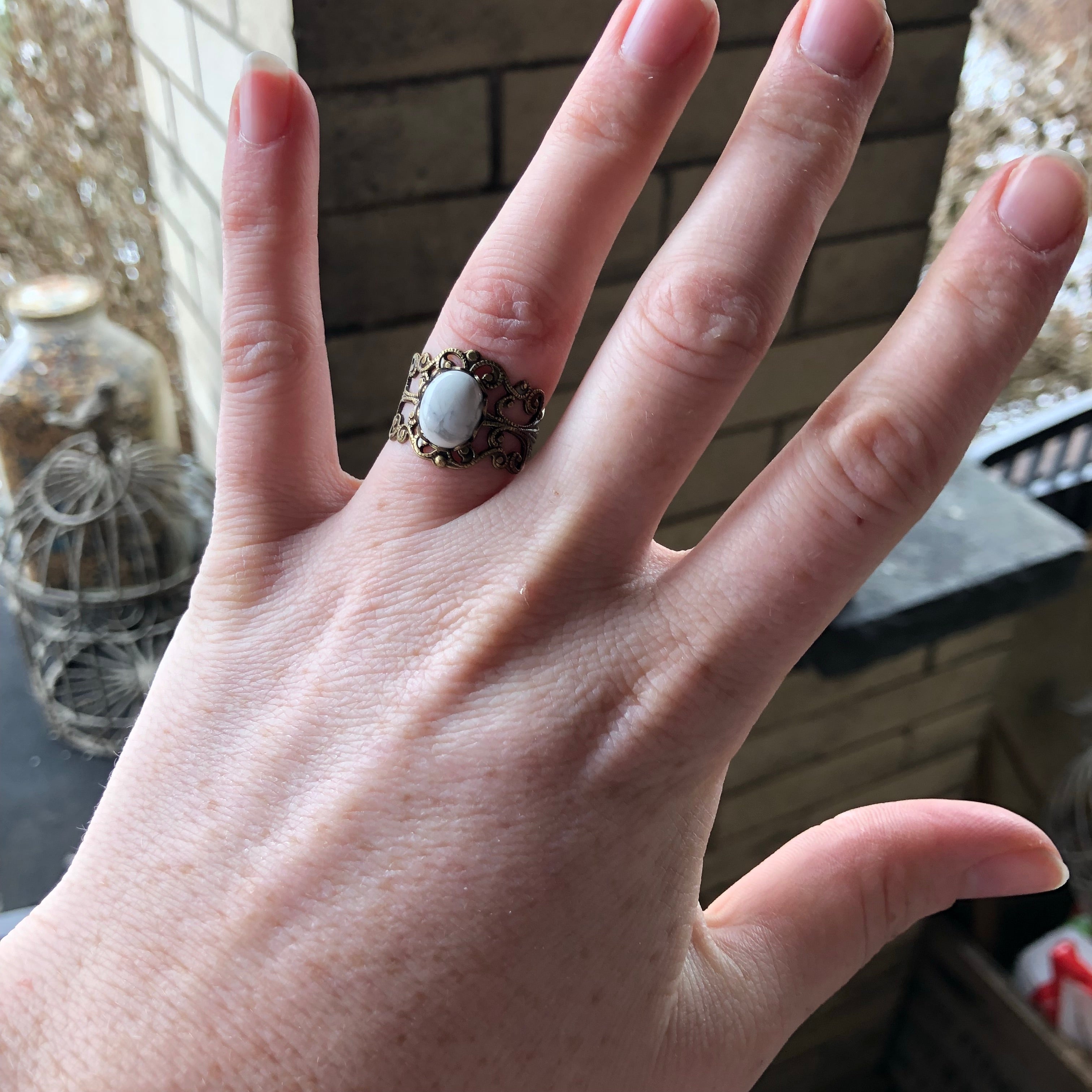 rich bronze colored antiqued brass modern vintage inspired adjustable filigree ring with a white marble howlite semi-precious mineral oval stone in the tanbi kei aesthetic