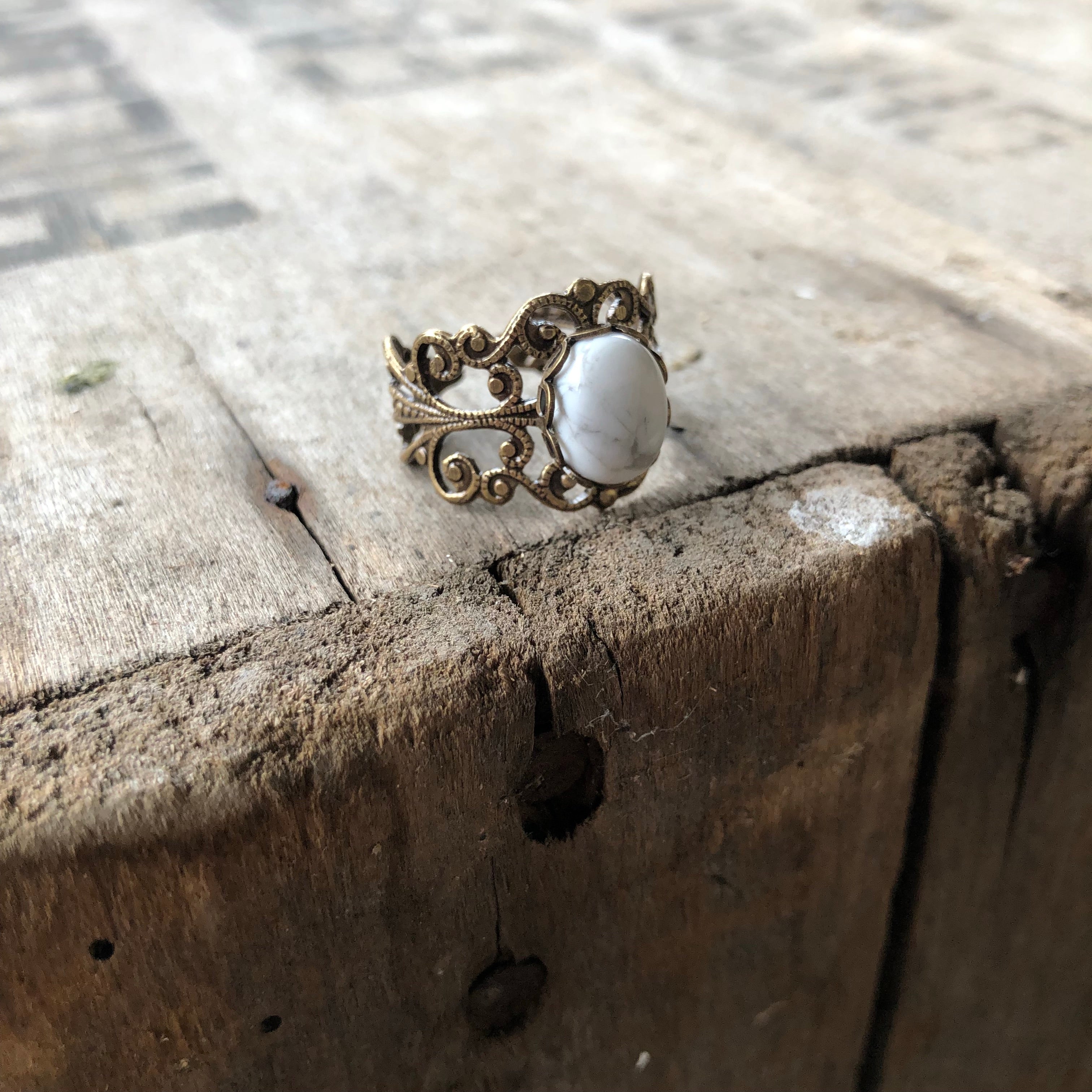 rich bronze colored antiqued brass modern vintage inspired adjustable filigree ring with a white marble howlite semi-precious mineral oval stone in the vanilla girl aesthetic