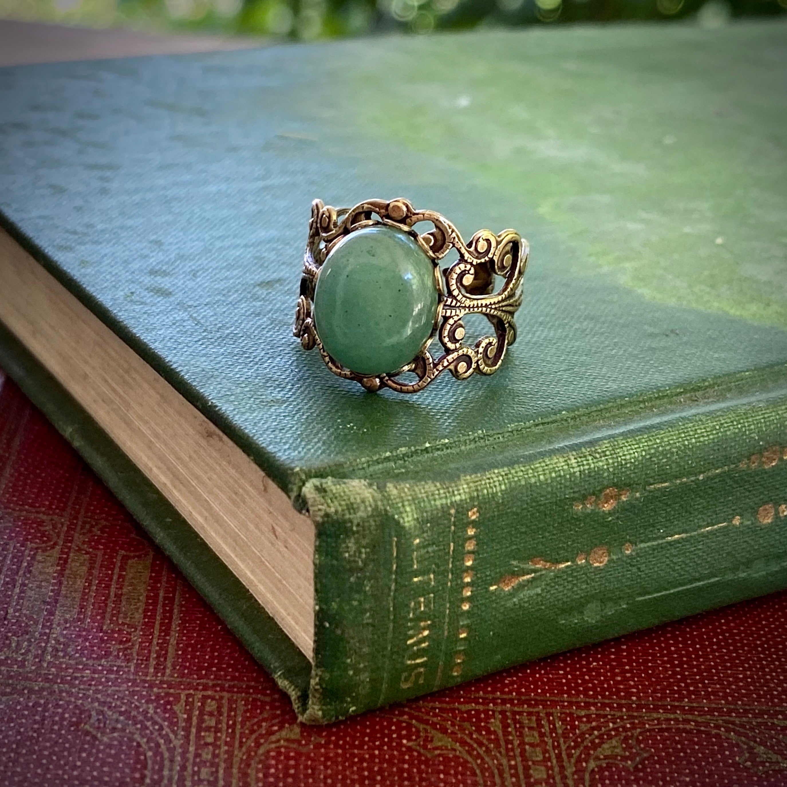 Antiqued brass adjustable mod vintage-inspired filigree ring with a green aventurine semi-precious stone mineral in the mori kei aesthetic