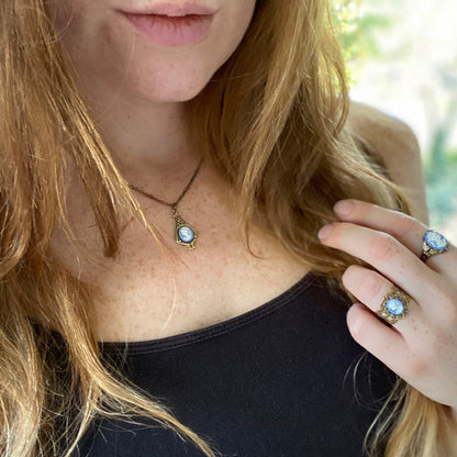 A set of light blue and white lady cameos on silver settings: two rings and a necklace.