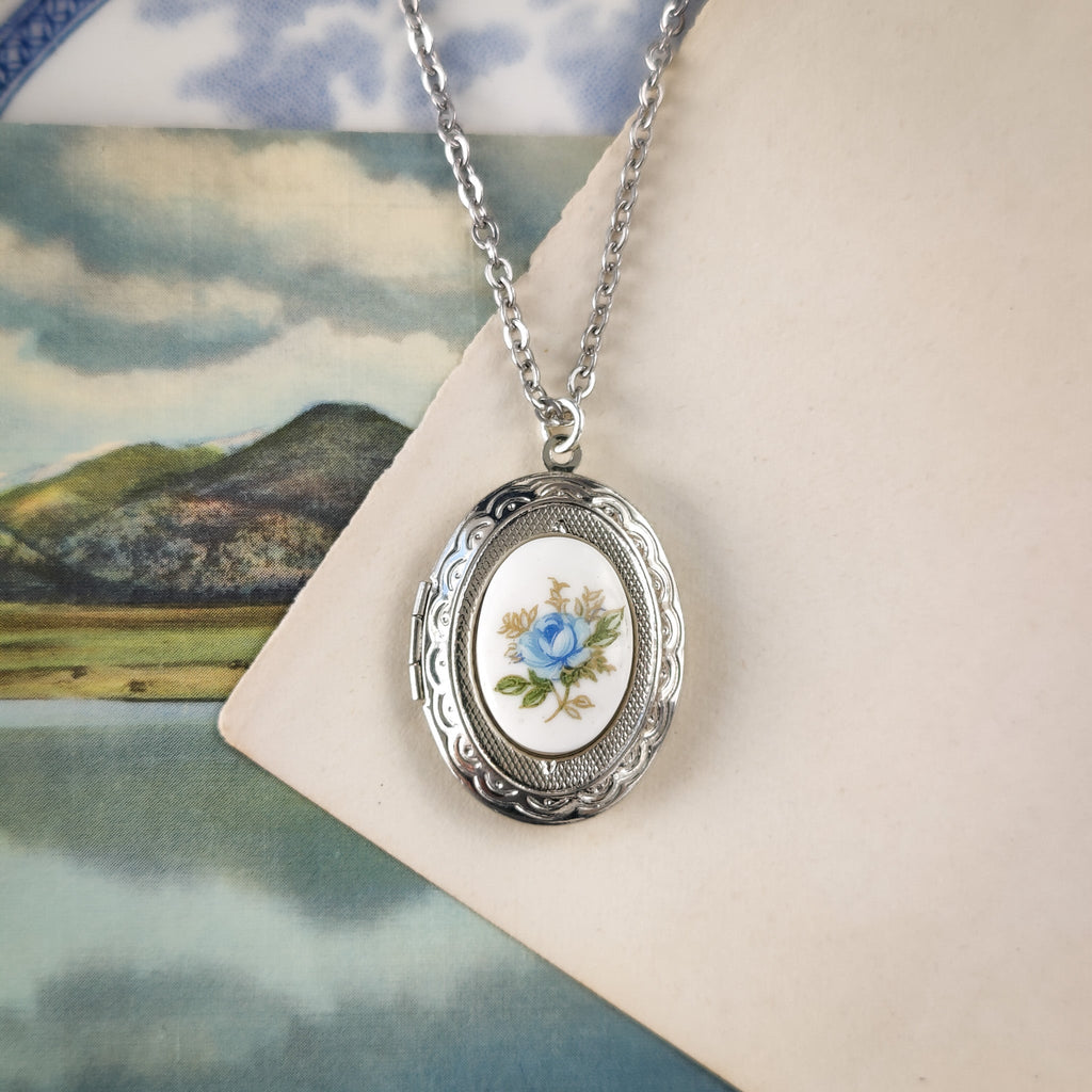 Silver vintage style locket with antique porcelain cameo with a blue rose