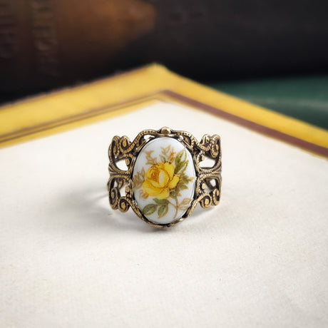 Antiqued brass filigree adjustable ring with an antique porcelain yellow rose cameo