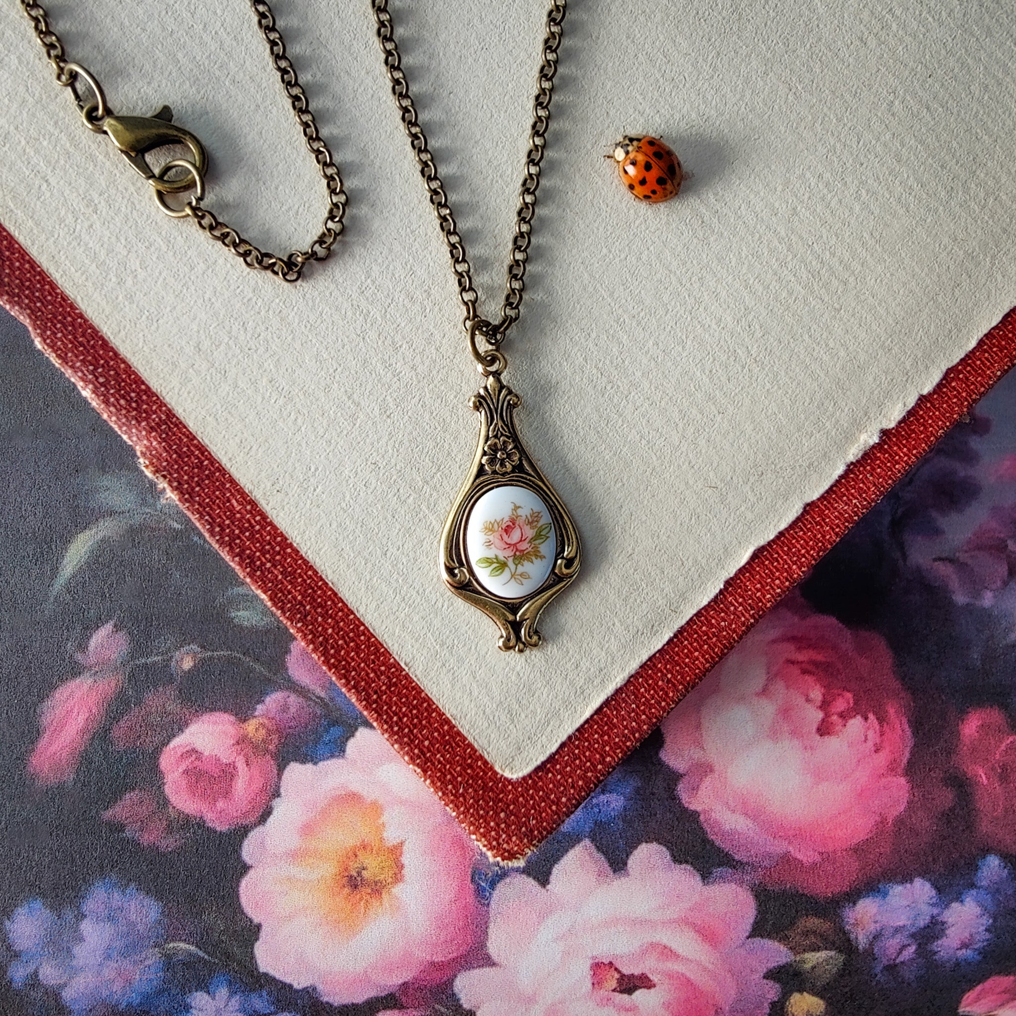 Antiqued retro-style drop necklace with vintage porcelain rose cameo