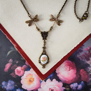 Antiqued vintage style dragonfly filigree teardrop necklace with antique ceramic rose cameo.
