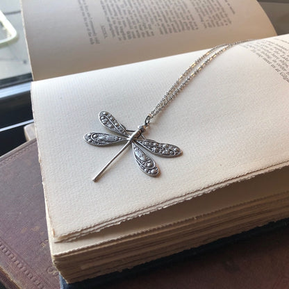 Antiqued silver dragonfly pendant on a simple chain.