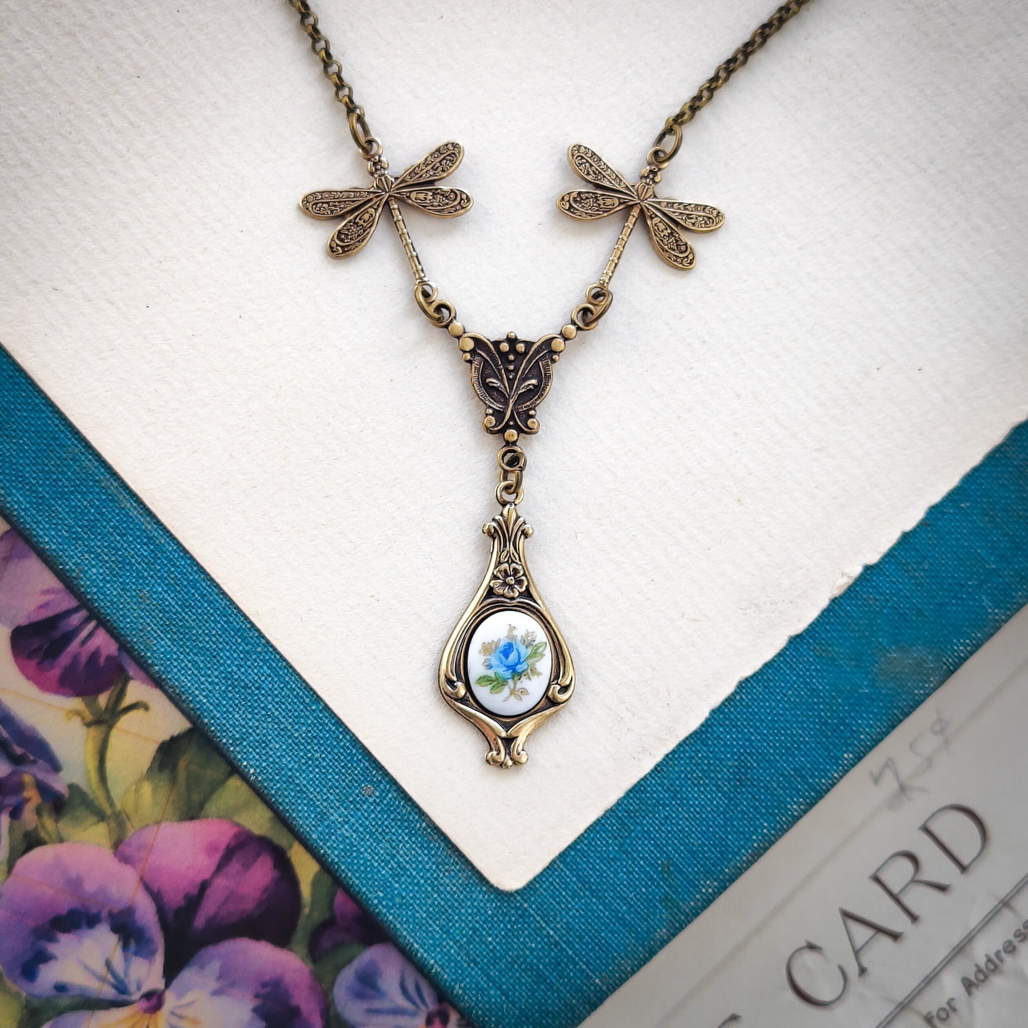 Antiqued vintage style dragonfly filigree teardrop necklace with antique ceramic rose cameo.