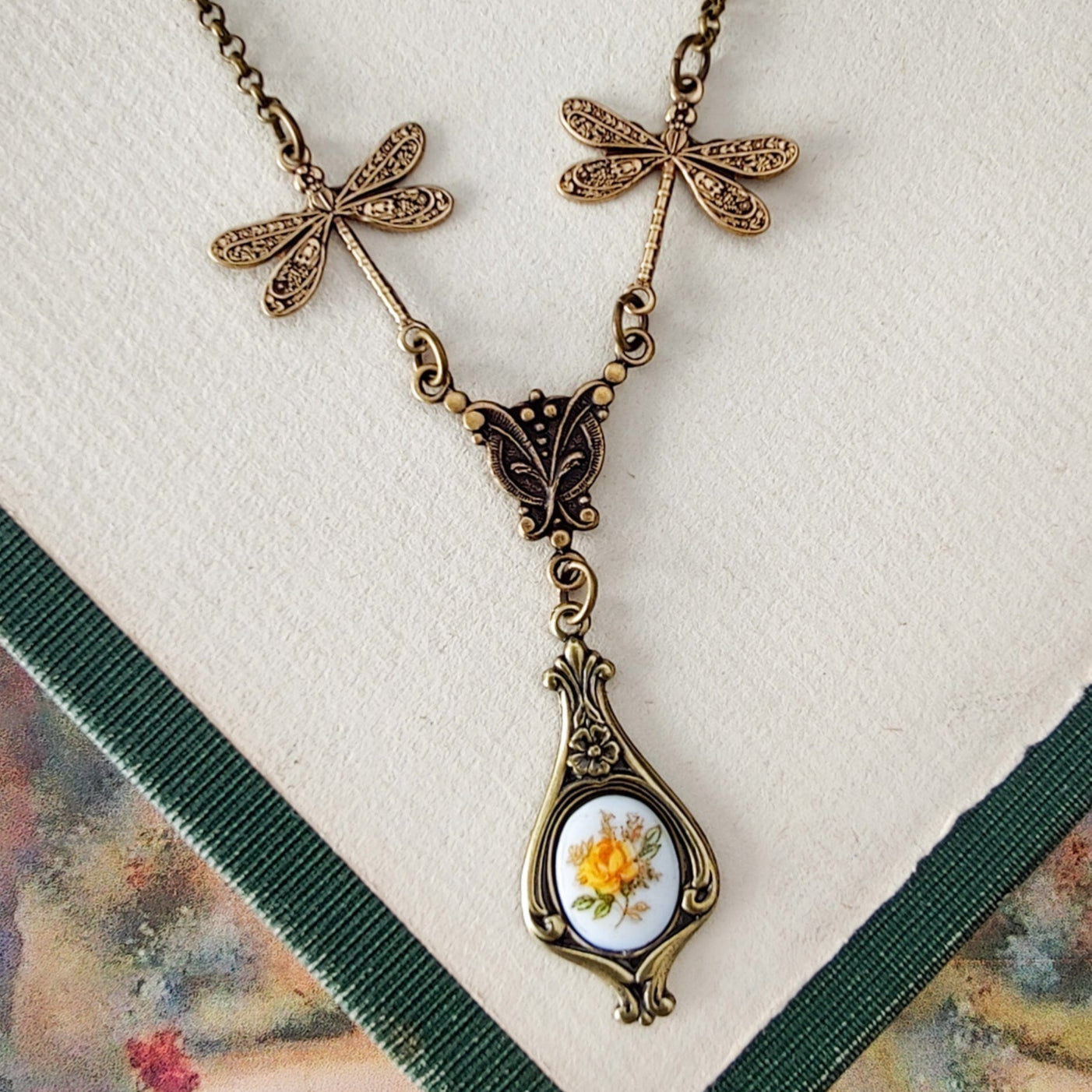 Antiqued vintage style dragonfly filigree teardrop necklace with antique ceramic rose cameo.