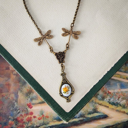 Antiqued vintage style dragonfly filigree teardrop necklace with antique ceramic rose cameo.