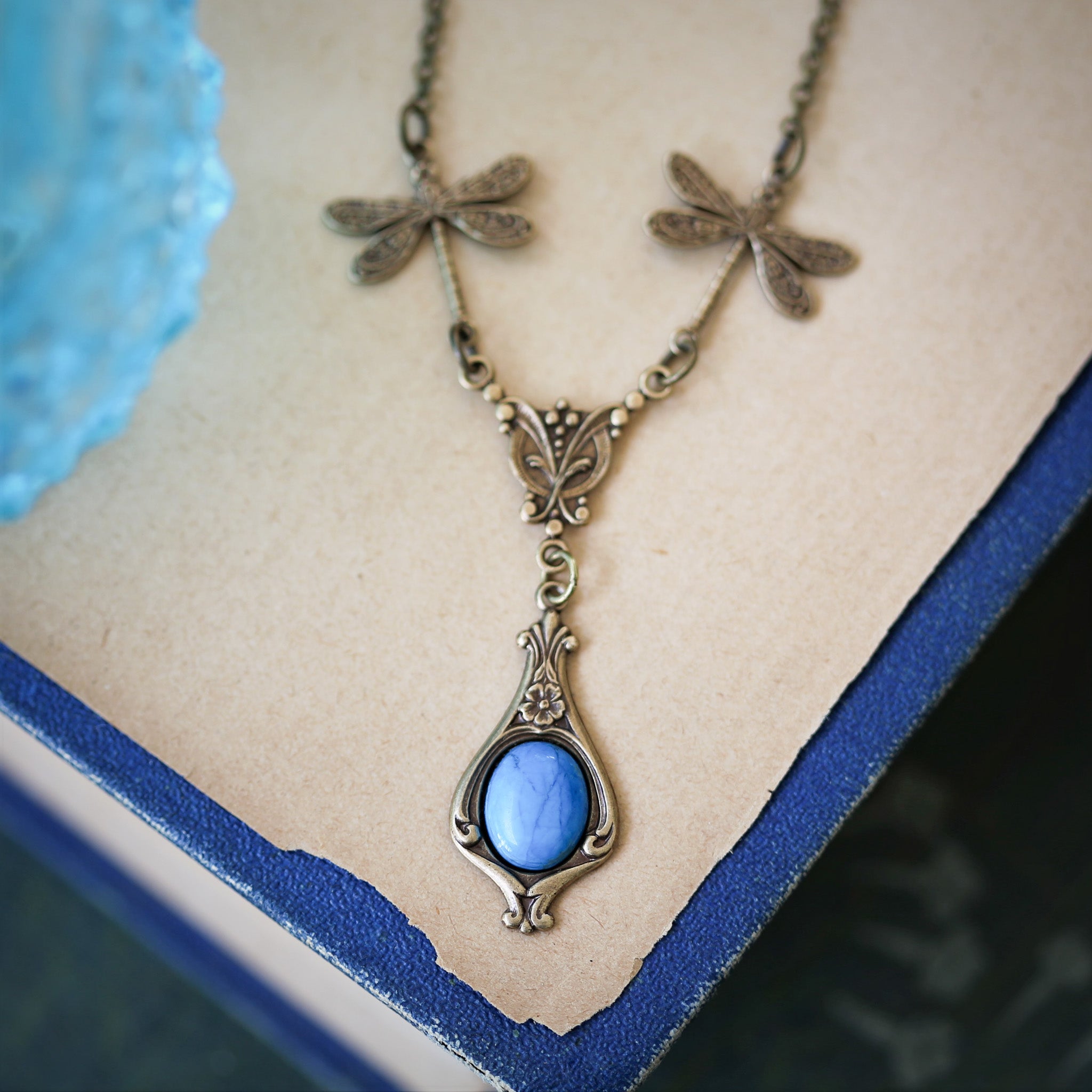 antiqued brass vintage-style dragonfly simple drop semi-precious stone mineral light blue howlite pendant in princess core aesthetic