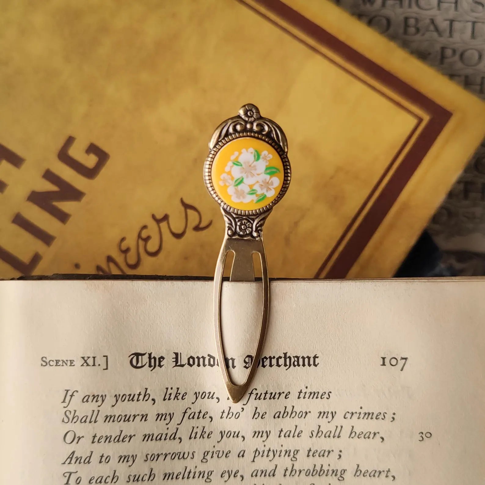 antiqued brass modern vintage inspired book mark clip page saver with a circle metal yellow flower motif a perfect gift for a literary afficionado.