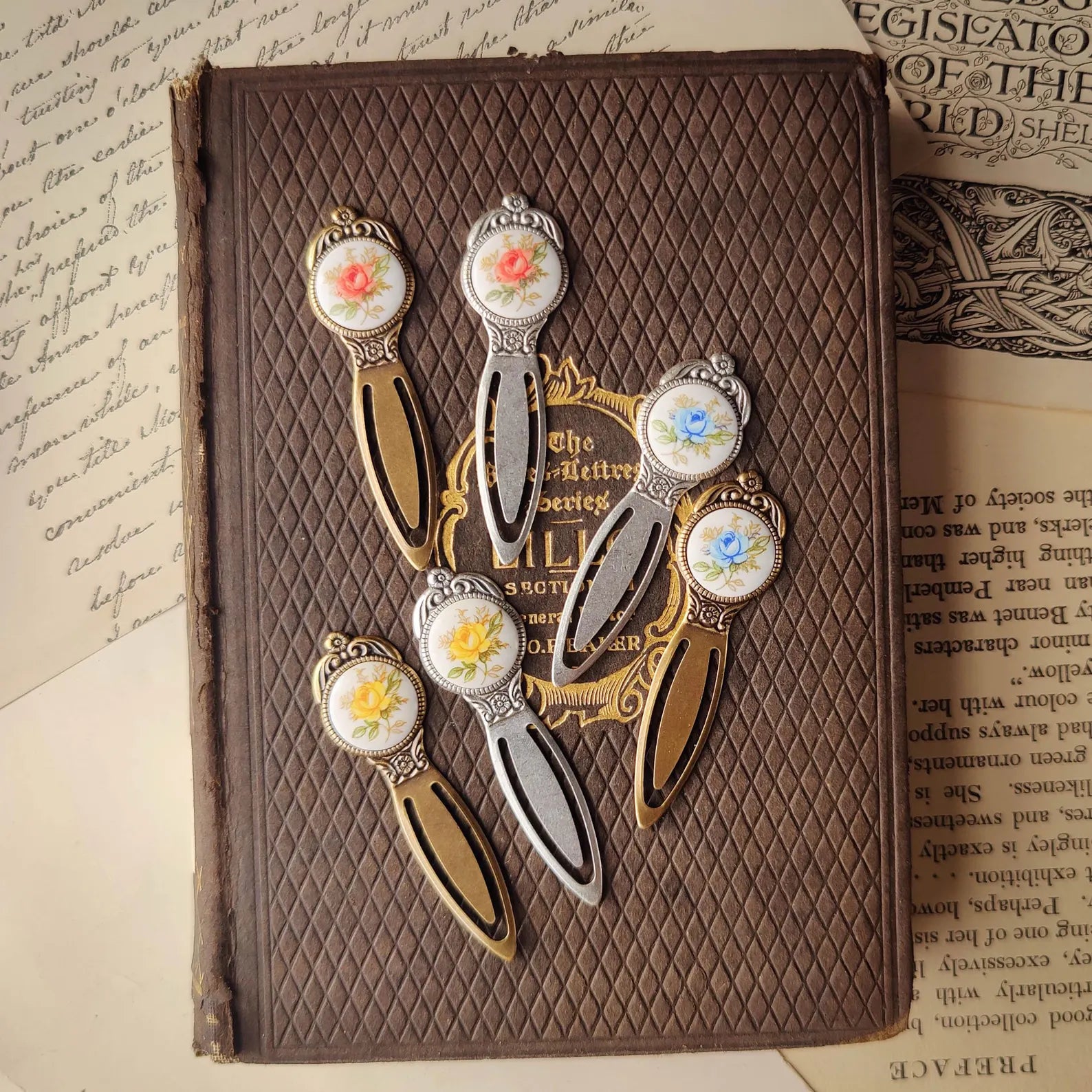 antiqued silver or brass modern vintage inspired blue, pink and yellow rose cabochon circle bookmarks.