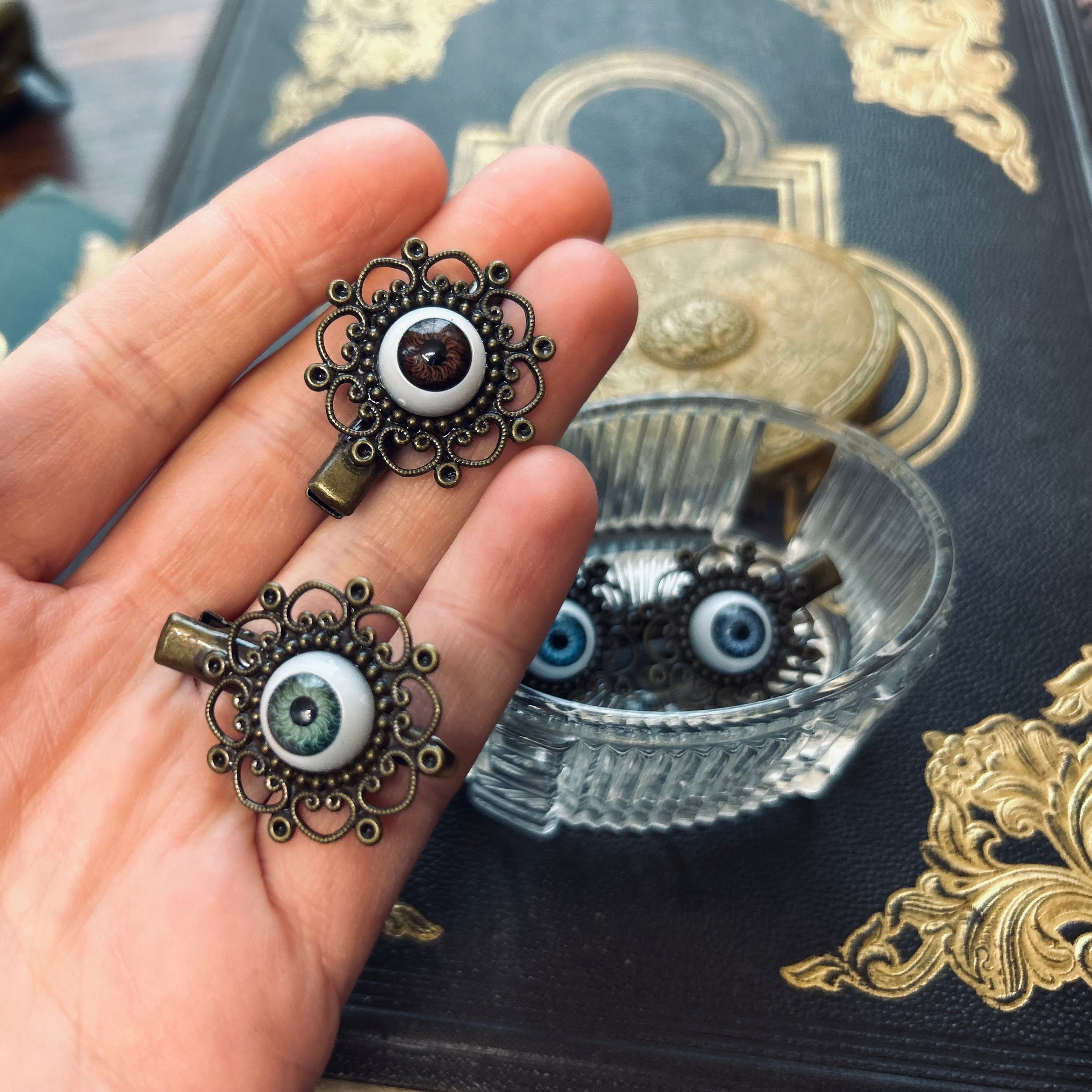 antiqued brass filigree green blue and brown all seeing eyeball hair clips in dark academia style