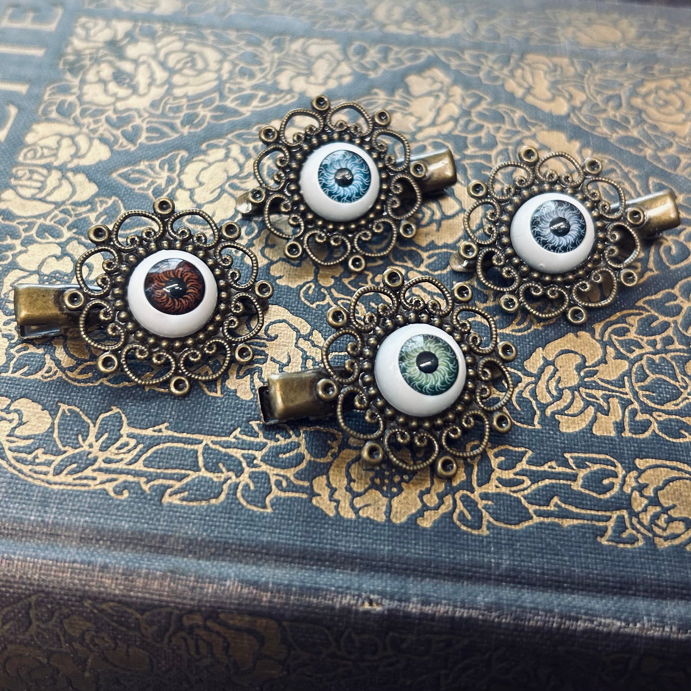 antiqued brass filigree green blue or green eyeball hair clips in Halloween style