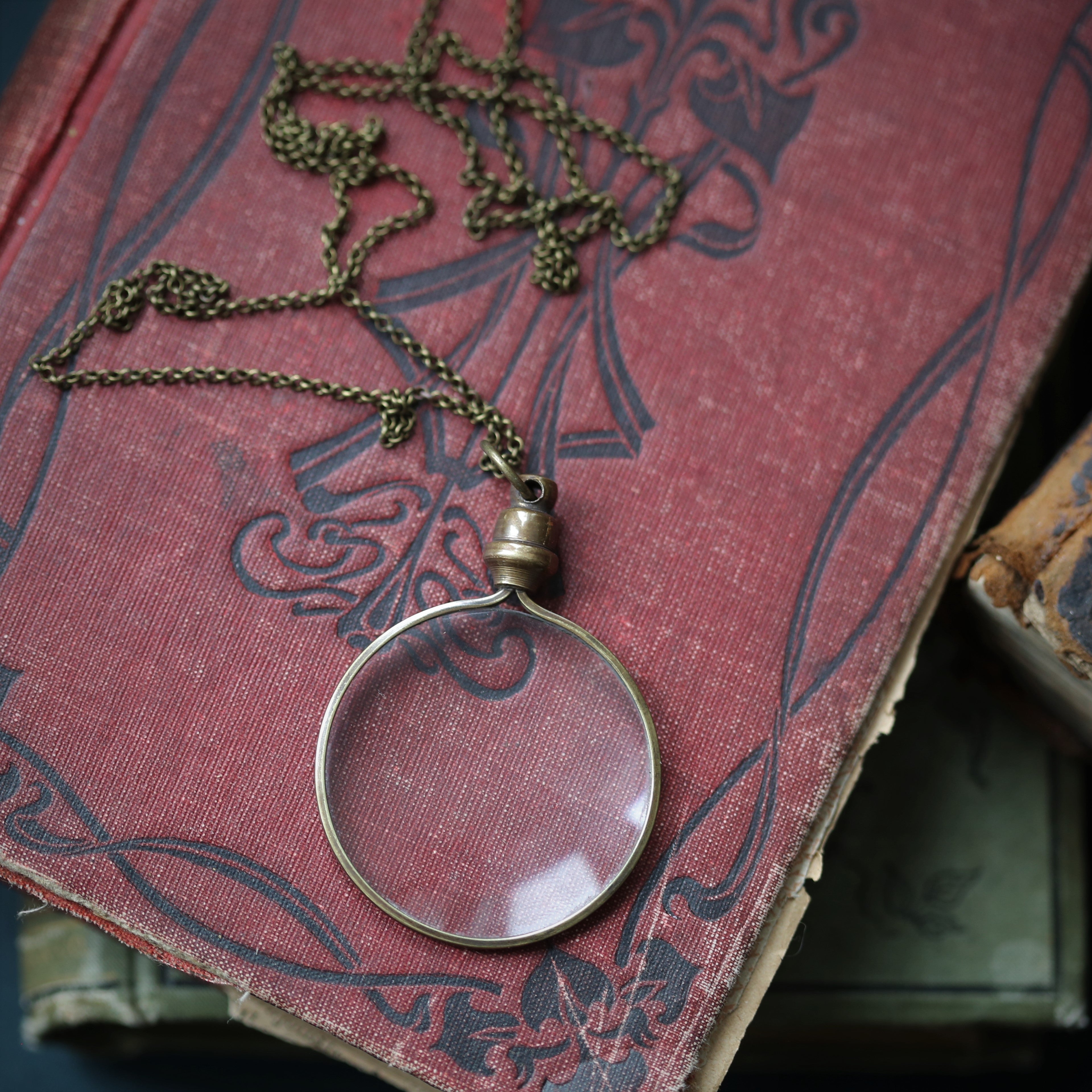 antiqued brass modern vintage inspired long monocle pendant necklace making a useful accessory