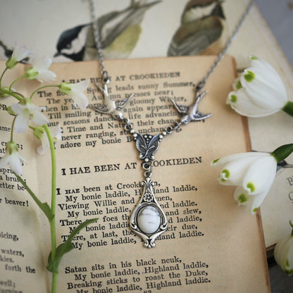 Silver vintage-style necklace with two birds and a white howlite drop