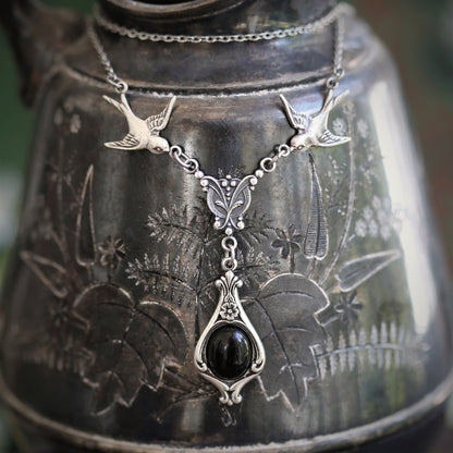 Antiqued silver vintage-style black onyx drop pendant featuring birds in victorian gothic style making a great necklace for a little black dress.