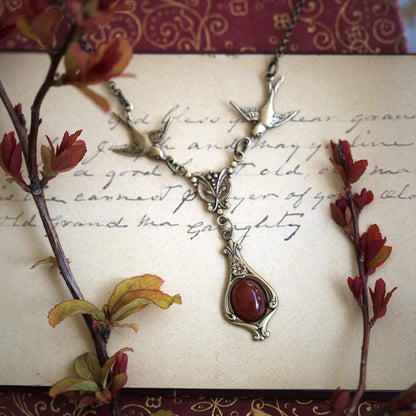 Antiqued brass vintage-style orange carnelian drop pendant featuring birds in autumn academia style gift.