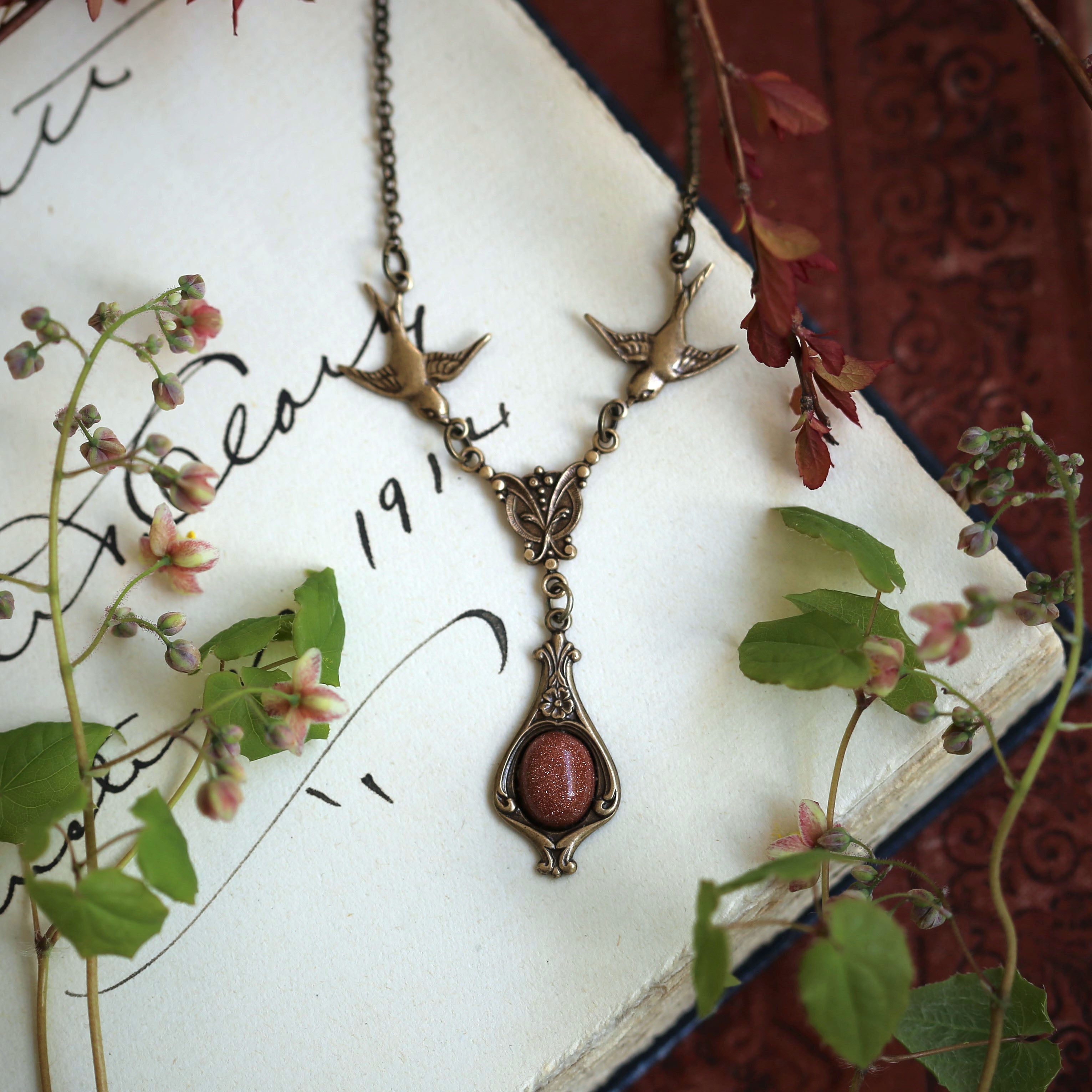 Antiqued brass vintage-style orange sunstone drop pendant featuring birds in autumn academia style gift.