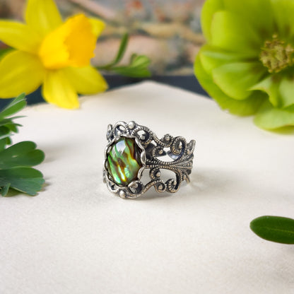 antiqued silver modern vintage style adjustable filigree ring with an iridescent green oval shell in the floral academia aesthetic