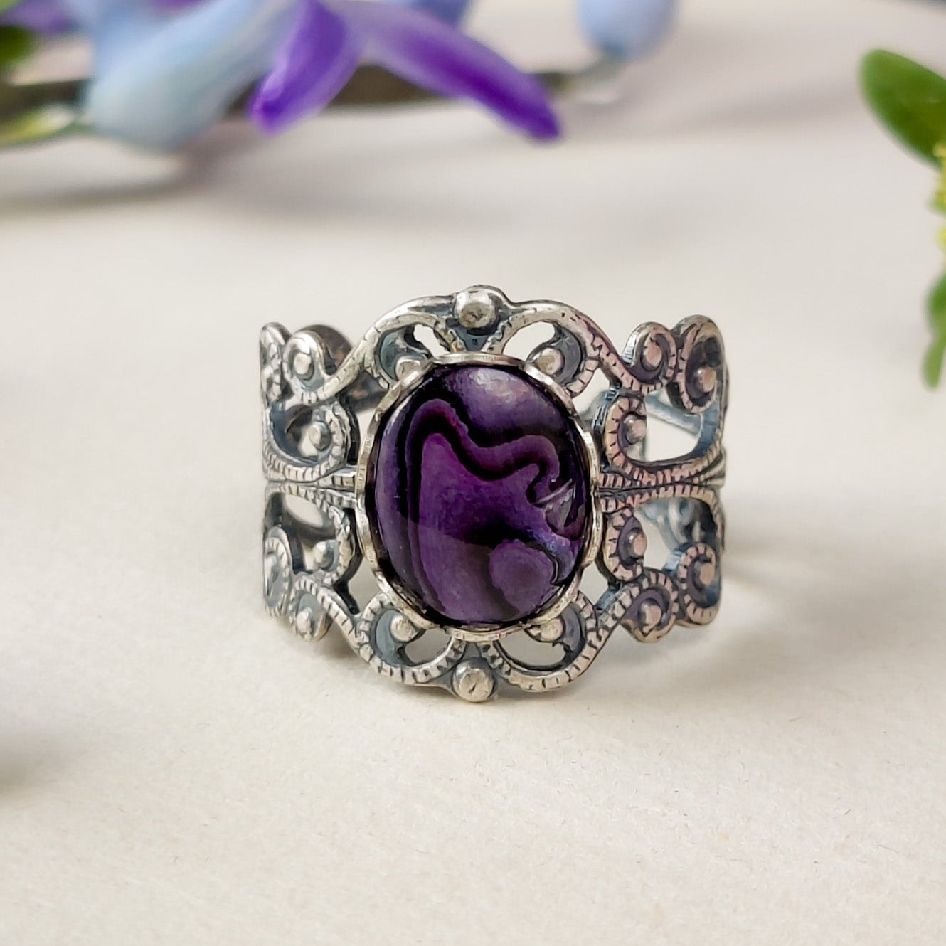 antiqued silver modern vintage inspired fully adjustable brass filigree band ring with an oval purple shell in pastel punk style