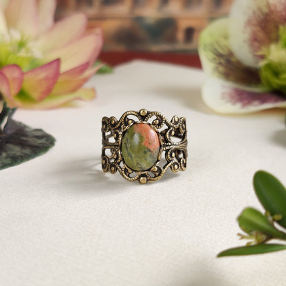 Antiqued brass modern vintage inspired adjustable filigree cocktail ring with orange and green unakite semi-precious stone oval mineral in a theater academia aesthetic