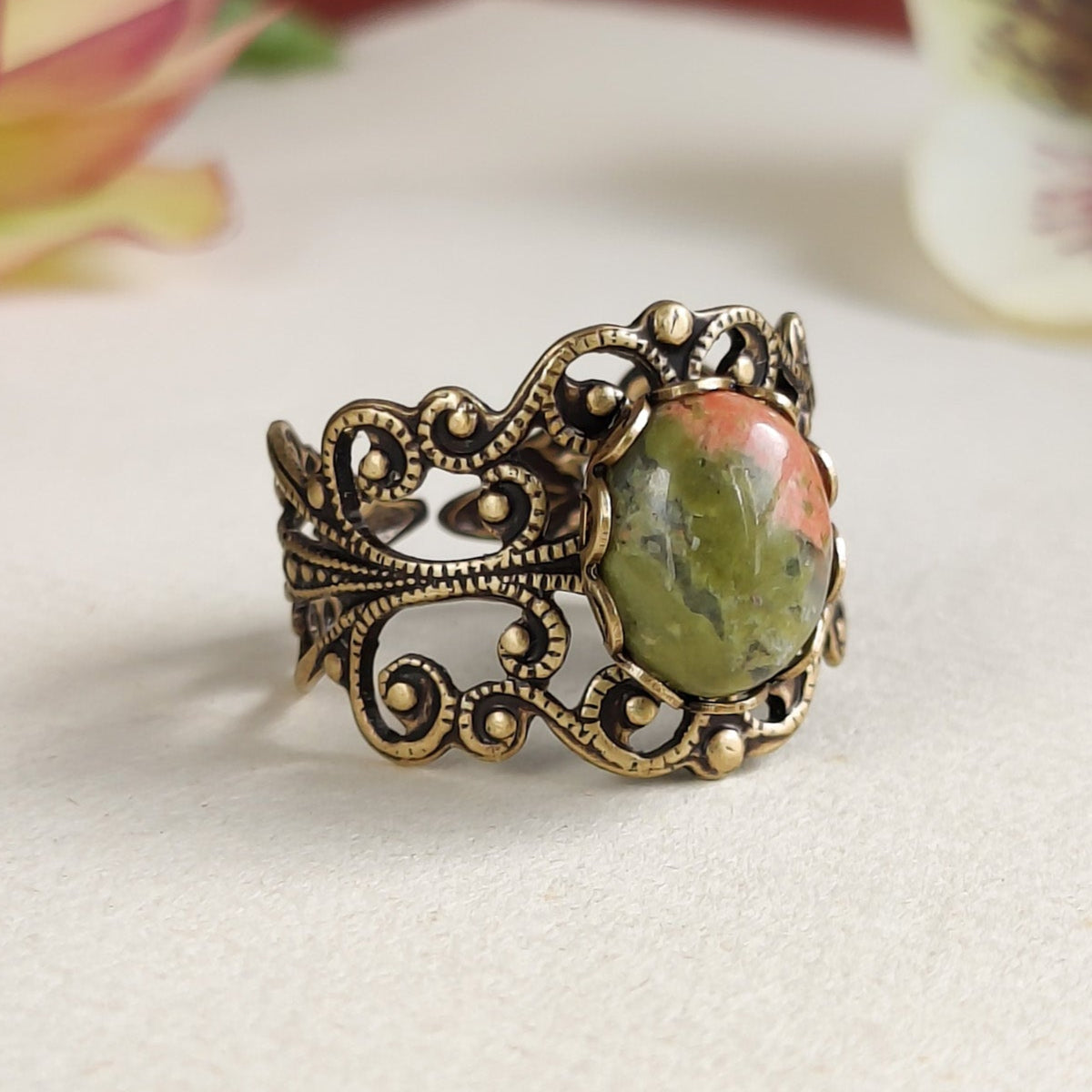 Antiqued brass modern vintage inspired adjustable filigree cocktail ring with orange and green unakite semi-precious stone oval mineral in a shabby chic aesthetic