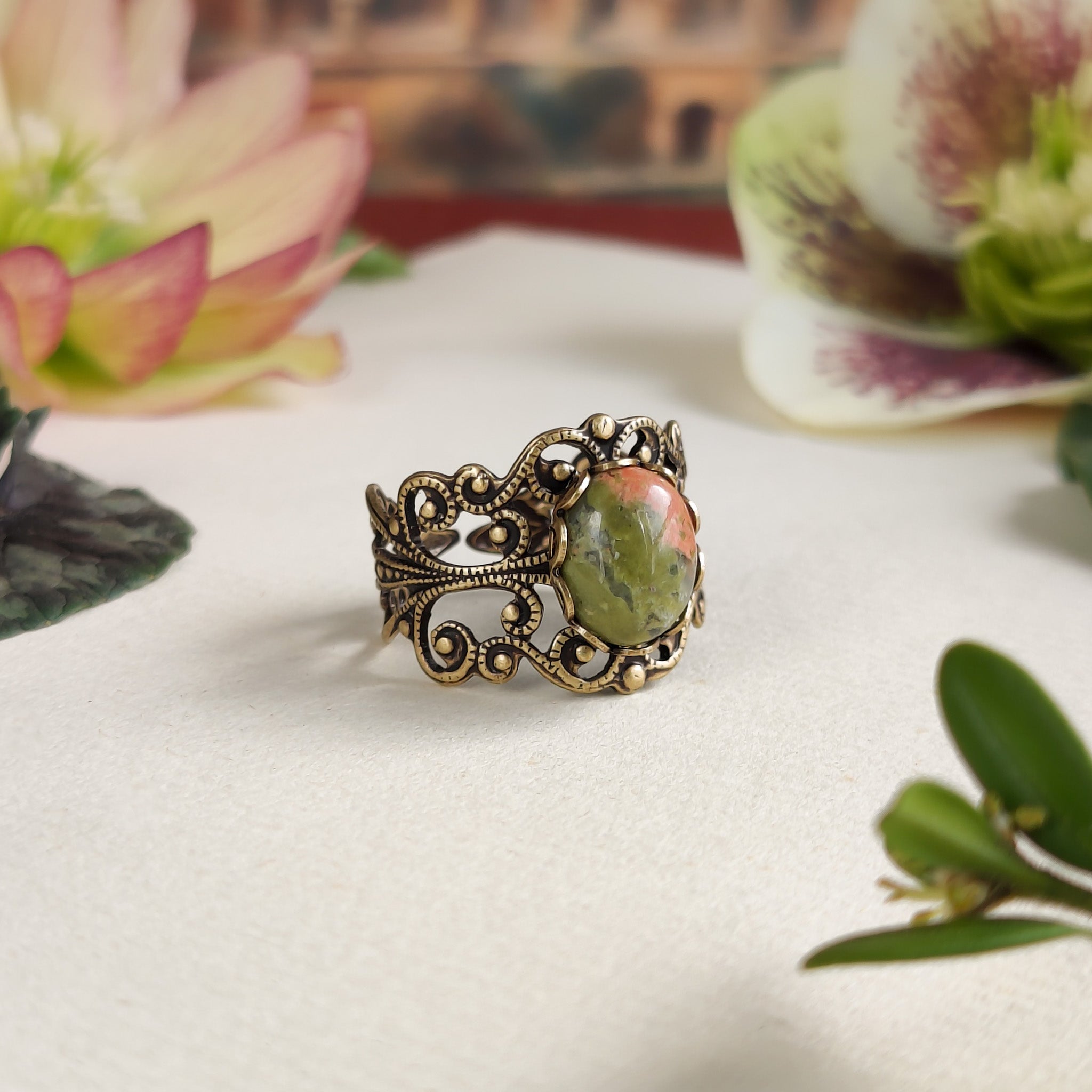 Antiqued brass modern vintage inspired adjustable filigree cocktail ring with orange and green unakite semi-precious stone oval mineral in a shabby chic aesthetic