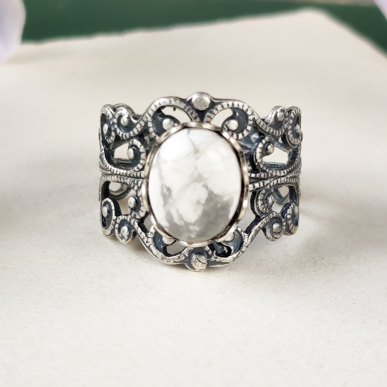 antiqued silver colored modern vintage inspired adjustable filigree ring with a white marble howlite semi-precious mineral oval stone in the lagenlook or boho aesthetic
