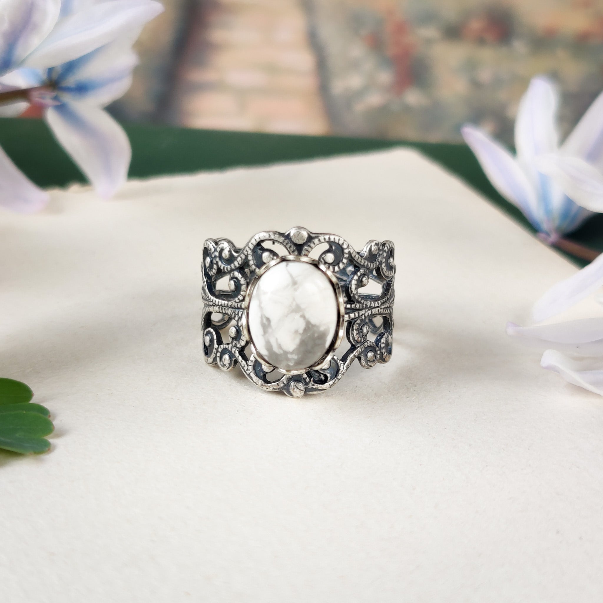 antiqued silver colored modern vintage inspired adjustable filigree ring with a white marble howlite semi-precious mineral oval stone in the lagenlook or boho aesthetic
