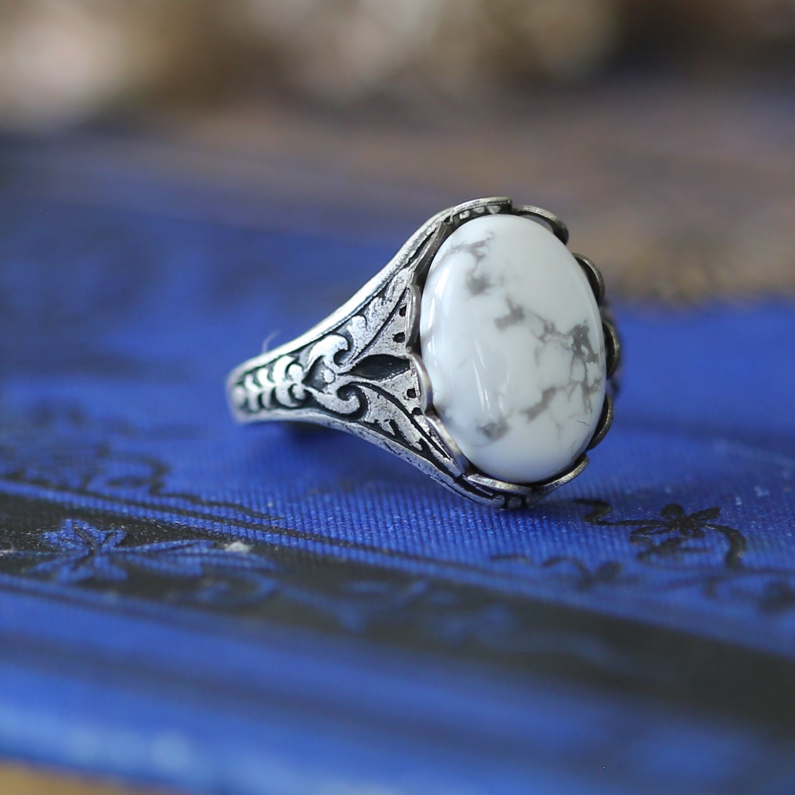 Antiqued silver vintage adjustable filigree oakleaf ring with a white howlite oval stone.