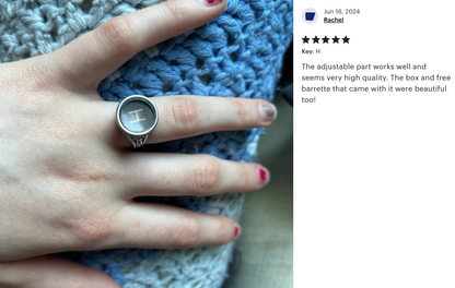 Silver vintage typewriter key ring alongside a customer's review of the ring. The review remarks on the adjustability and high quality of the ring.
