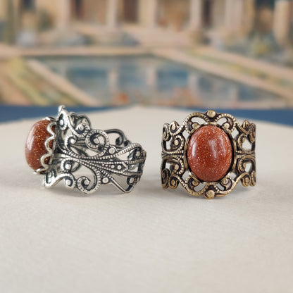 Antiqued brass modern vintage inspired adjustable filigree ring set with an orange goldstone semi-precious mineral in the earthy period piece aesthetic