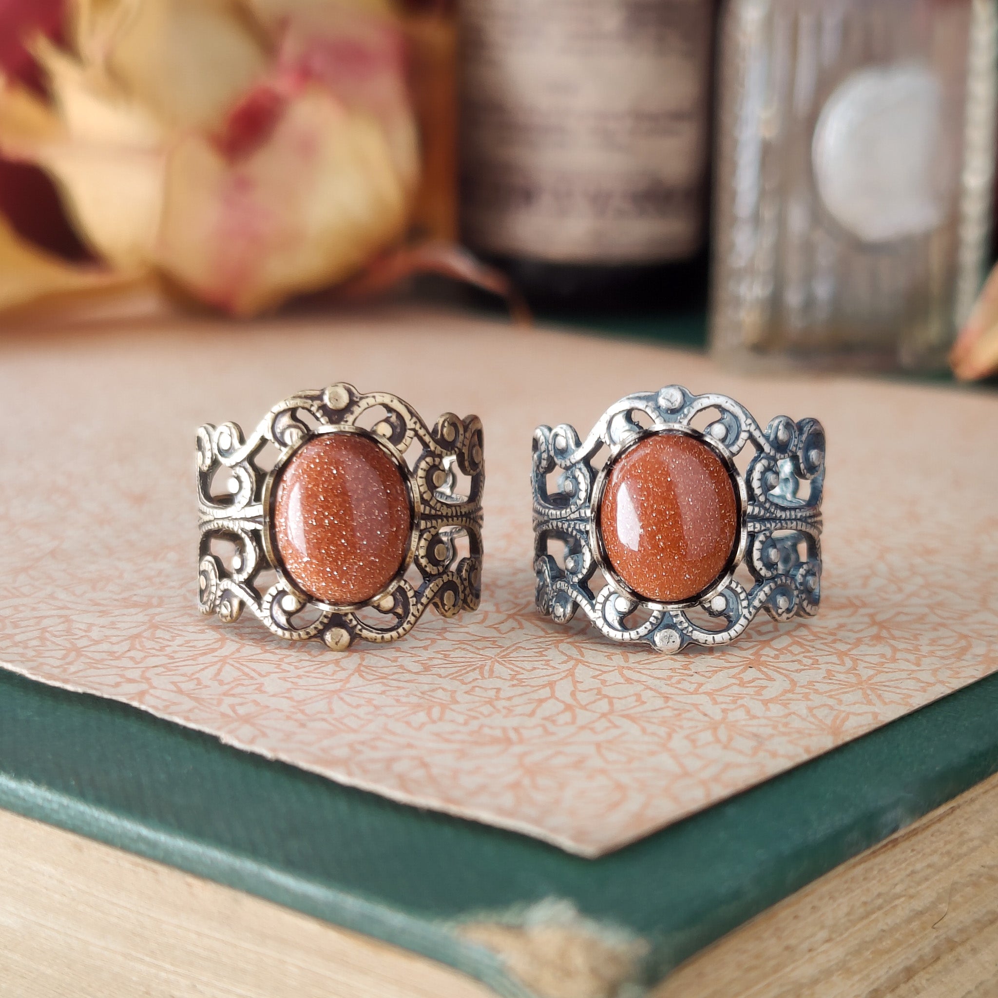 Antiqued brass modern vintage inspired adjustable filigree ring set with an orange goldstone semi-precious mineral in the historical aesthetic