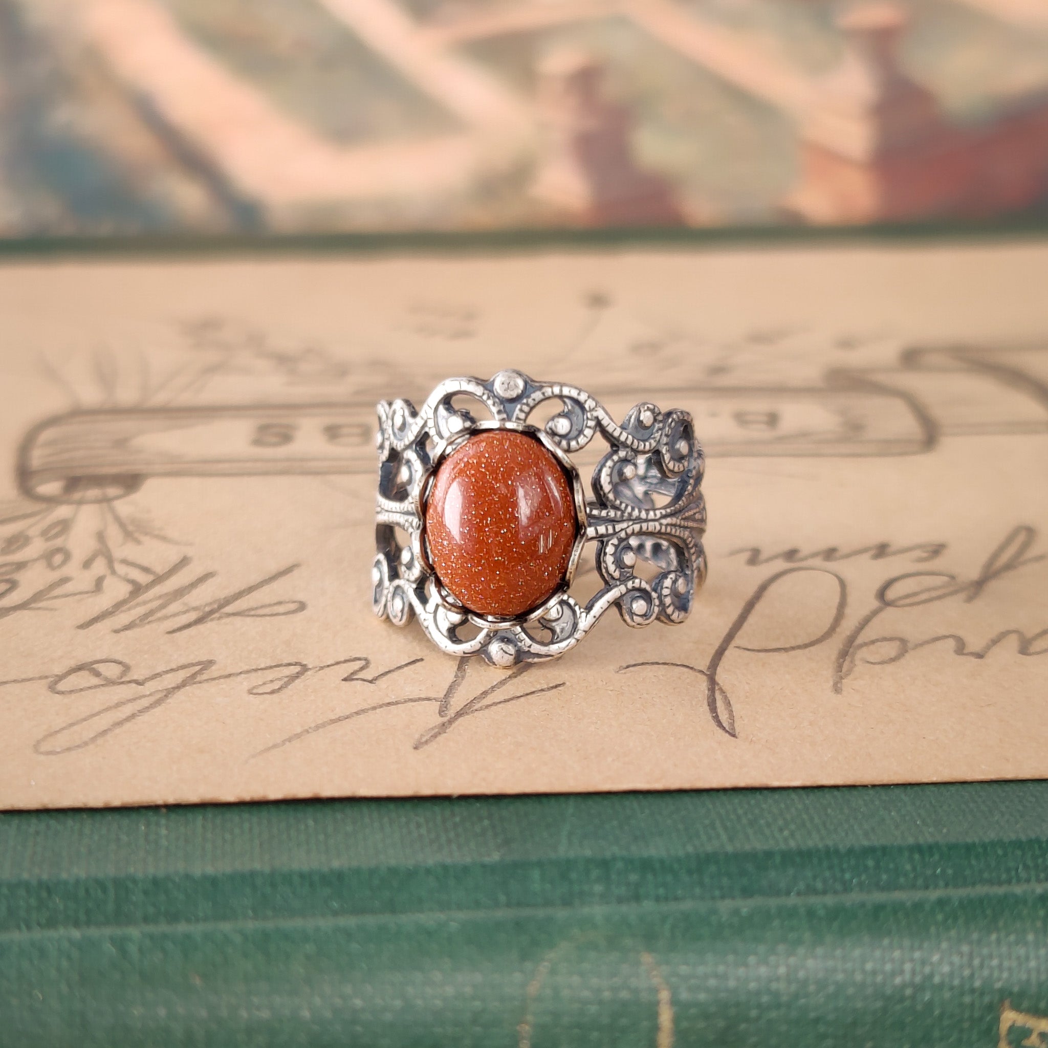 Antiqued brass modern vintage inspired adjustable filigree ring set with an orange goldstone semi-precious mineral in the timeless antique look aesthetic