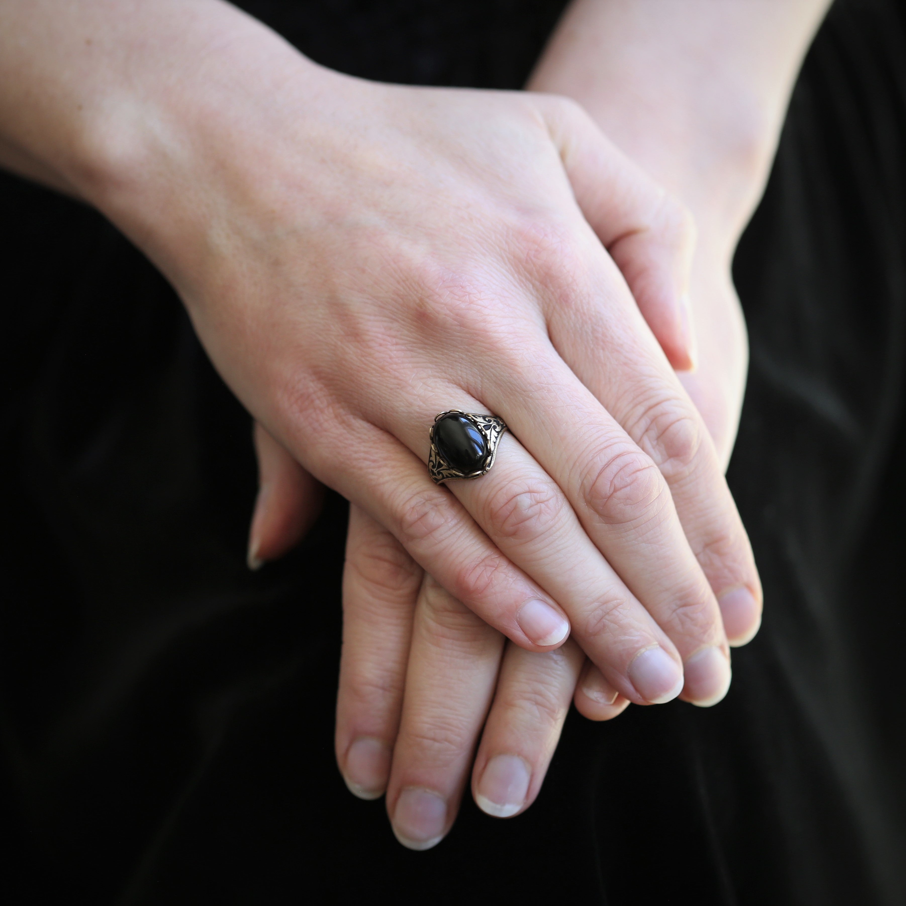 brass Victorian style mourning ring with antiqued brass adjustable band and a black gothic style oval onyx stone set in a bezel.