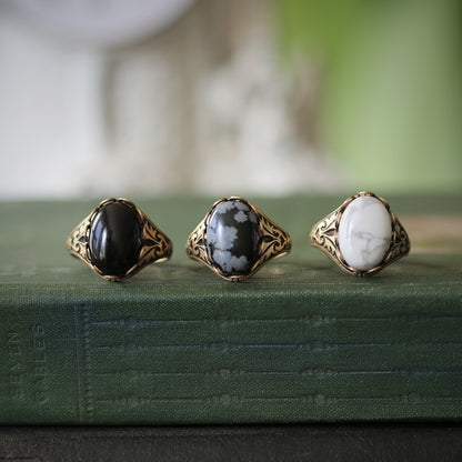 antiqued brass vintage-stye adjustable cocktail ring set with white black and grey howlite onyx and snowflake obsidian oval semi-precious stone cabochon in winter academia style