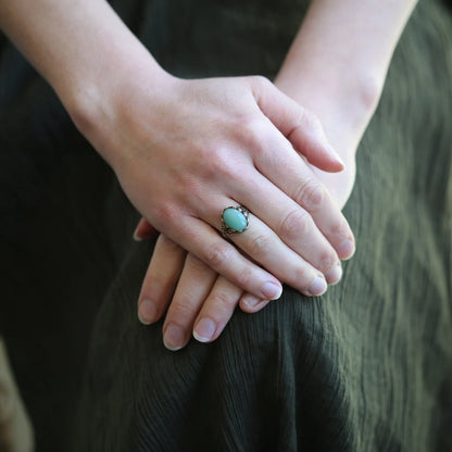 antiqued brass vintage style adjustable green aventurine gardencore, mosscore, woodlandcore, or cottage core statement ring modeled with green dress