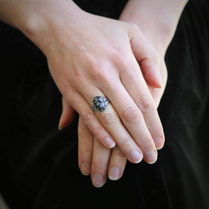 antiqued silver vintage-stye adjustable statement ring with black and gray speckled snowflake obsidian oval stone cabochon in winter academia style