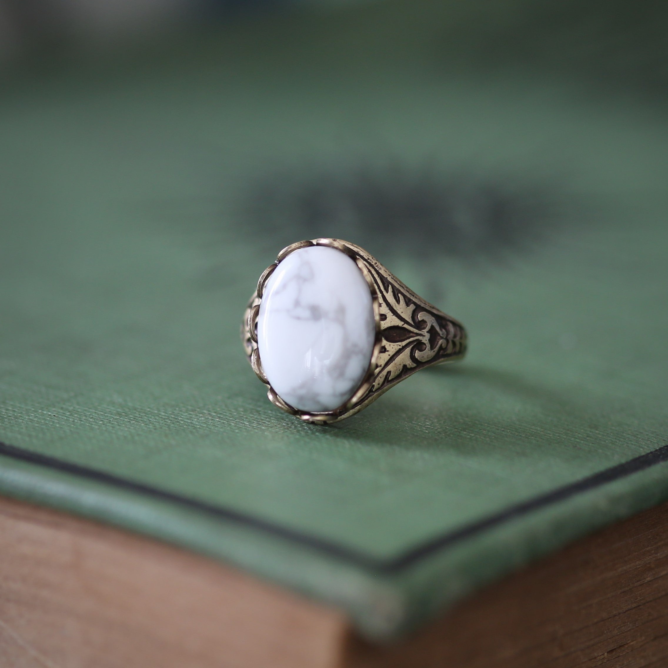 antiqued brass vintage-stye adjustable cocktail ring with white and grey howlite  oval semi-precious stone cabochon in winter academia style