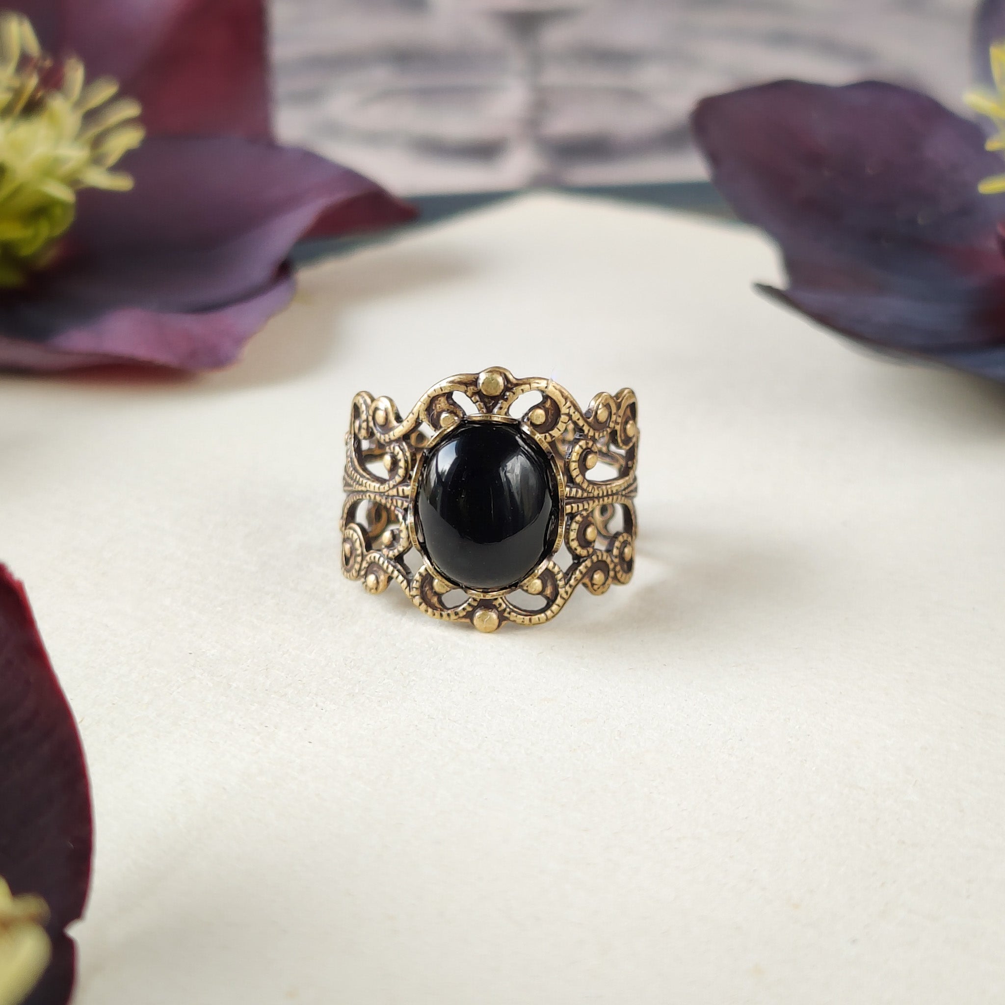 Antiqued brass modern vintage inspired adjustable filigree statement ring with a black oval onyx semi-precious stone mineral cabochon in dark cottagecore style