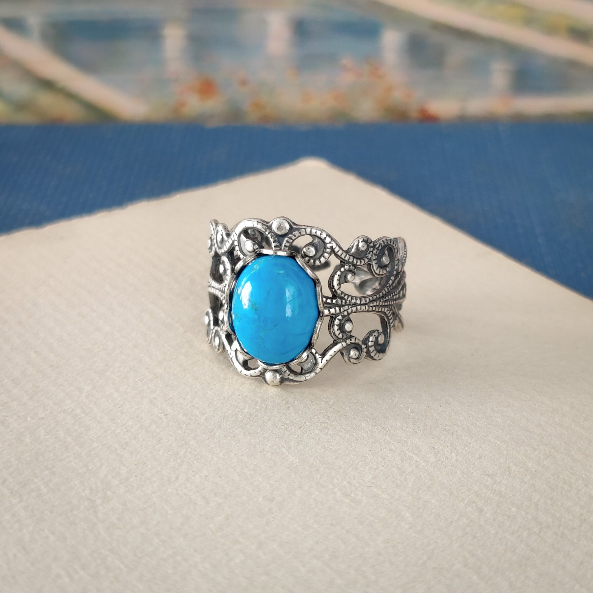 antiqued silver modern vintage inspired resizeable filigree statement ring with a turquoise blue howlite oval semi-precious mineral stone in the vibrant academia fashion aesthetic.