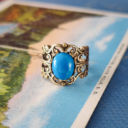 antiqued brass modern vintage inspired resizable filigree statement ring with a turquoise blue howlite oval semi-precious mineral stone in the soft girl fashion aesthetic.