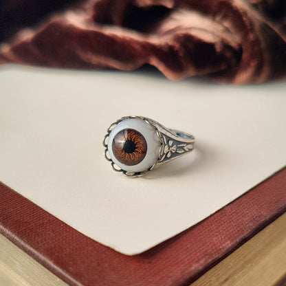 antiqued silver cryptidcore adjustable fairytale spooky cocktail ring with a brown doll's evil eye in goblin academia.