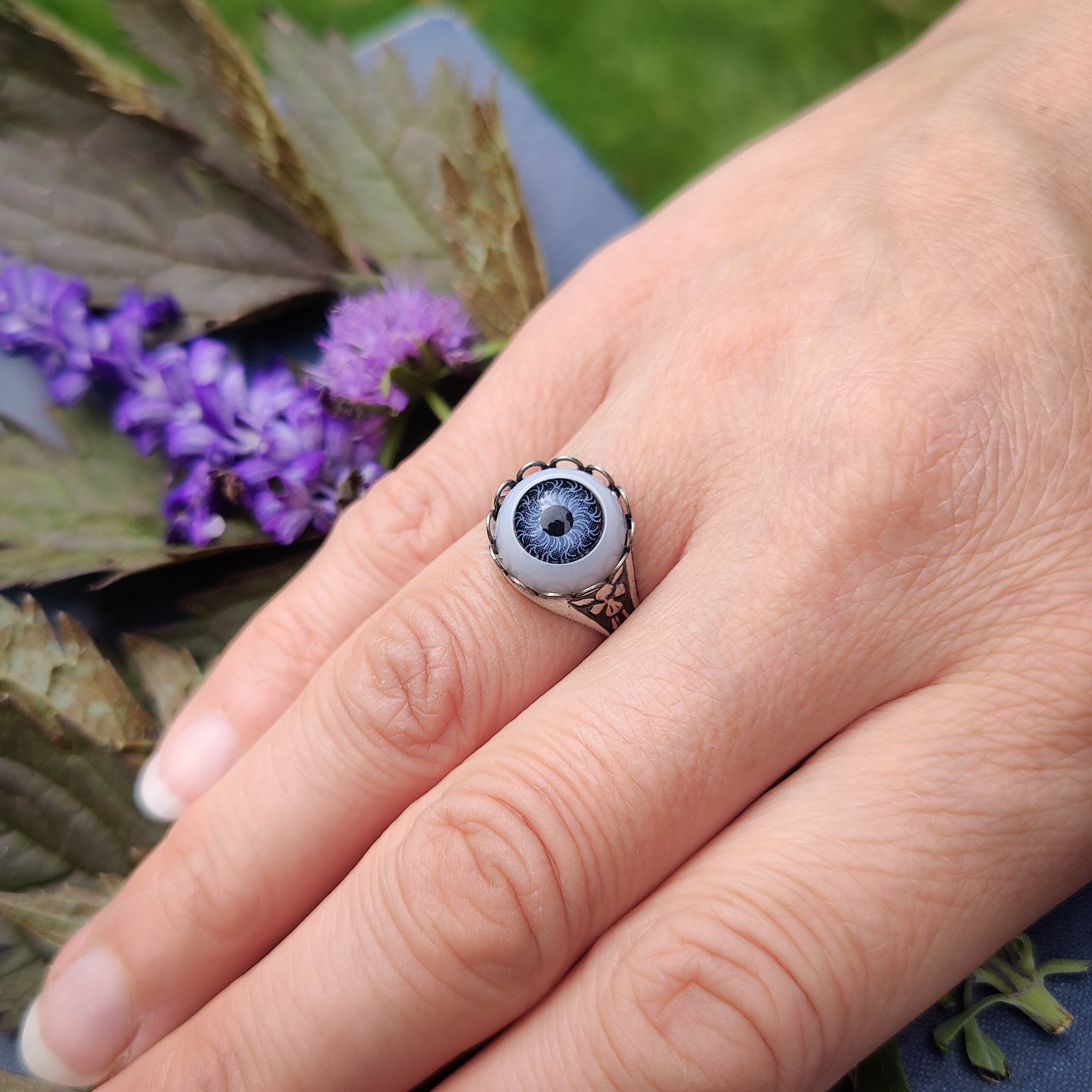 antiqued silver dark academia adjustable classic spooky cocktail ring with a light blue doll's evil eye.