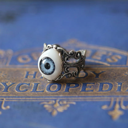 vintage style antiqued silver adjustable filigree ring with a blue oval evil eye in Halloween witch style