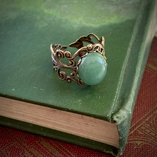 Antiqued brass filigree adjustable ring with oval green aventurine stone by ragtrader vintage.