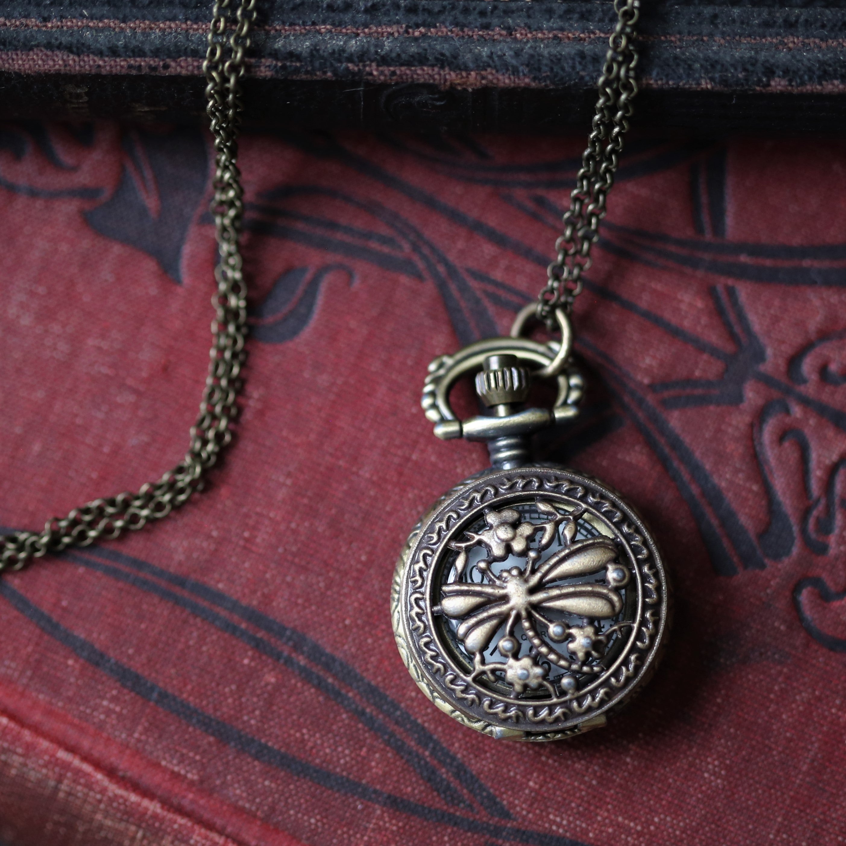 antiuqed brass wearable pocket watch necklace with dragonfly. Battery operated.